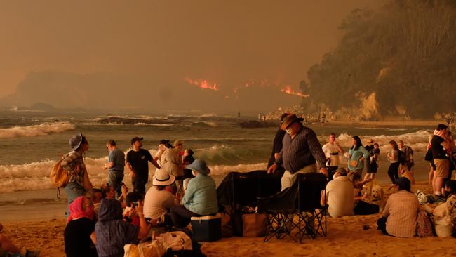 Locals seek refuge from bushfire at Malua Bay, just south of Batemans Bay on the NSW South Coast. Picture: Alex Coppel.