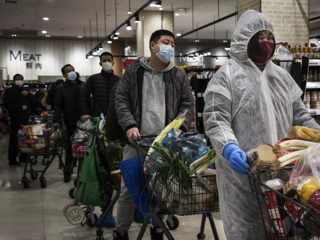 WUHAN, CHINA - FEBRUARY 12:  (CHINA OUT) Residents wear protective masks as they line up in the supermarket  on February 12, 2020 in Wuhan, Hubei province, China. Flights, trains and public transport including buses, subway and ferry services have been closed for 21 days. The number of those who have died from the Wuhan coronavirus, known as 2019-nCoV, in China climbed to 1117.  (Photo by Stringer/Getty Images)