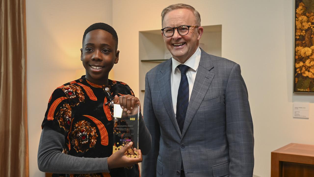 Ozi Egesi, from Perth, collects his trophy from Prime Minister Anthony Albanese. Picture: Martin Ollman