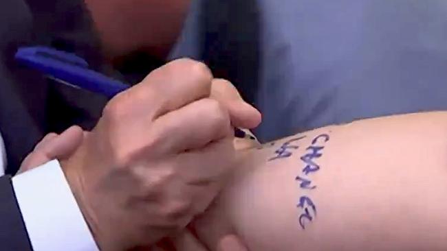 Prime Minister Anthony Albanese signs journalist's arm with “NO CHANGE TO WA GST”. Picture: ABC