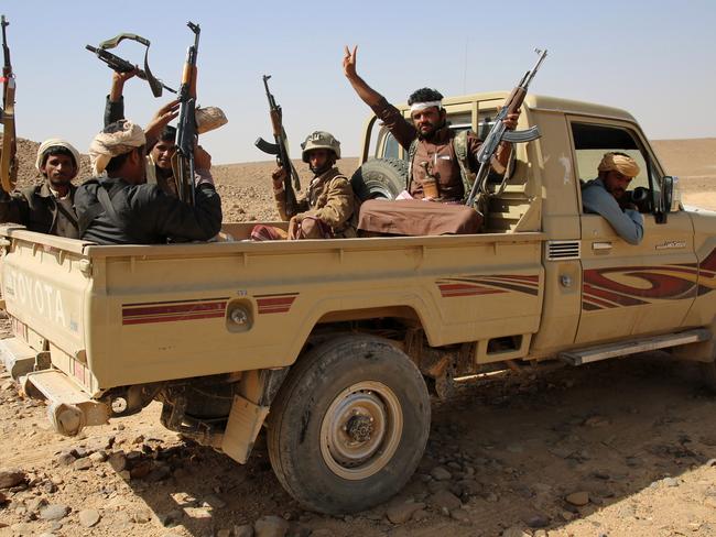 Armed Yemeni tribesmen from the Popular Resistance Committees, supporting forces loyal to Yemen’s Saudi-backed President Abedrabbo Mansour Hadi, raise their weapons from the back of a pick-up truck. The growth of Al-Qaeda in the country is deemed a threat to the US next year. Picture: ABDULLAH AL-QADRY