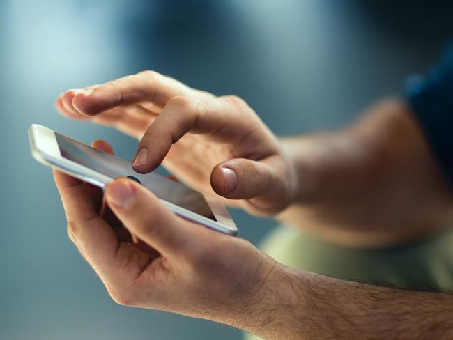 Generic Male hands typing on smartphone. Picture: Istock