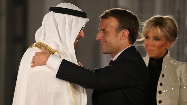 Abu Dhabi Crown Prince Mohammed bin Zayed Al-Nahyan (L) greets French President Emmanuel Macron and his wife Brigitte Macron at the entrance of the Louvre Abu Dhabi Museum on November 8, 2017 during its inauguration.