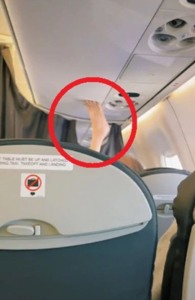 A woman a few rows in front with her leg stretched so high, her bare foot was touching the overhead locker. Picture: TikTok/jadethirlwall