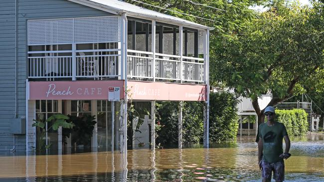 A man walking through a flooded Brisbane street on Tuesday March 1 2022. Picture: Zak Simmonds