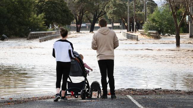 The Bickley family looks over floodwater over Franklin St in Traralgon. Picture: David Caird