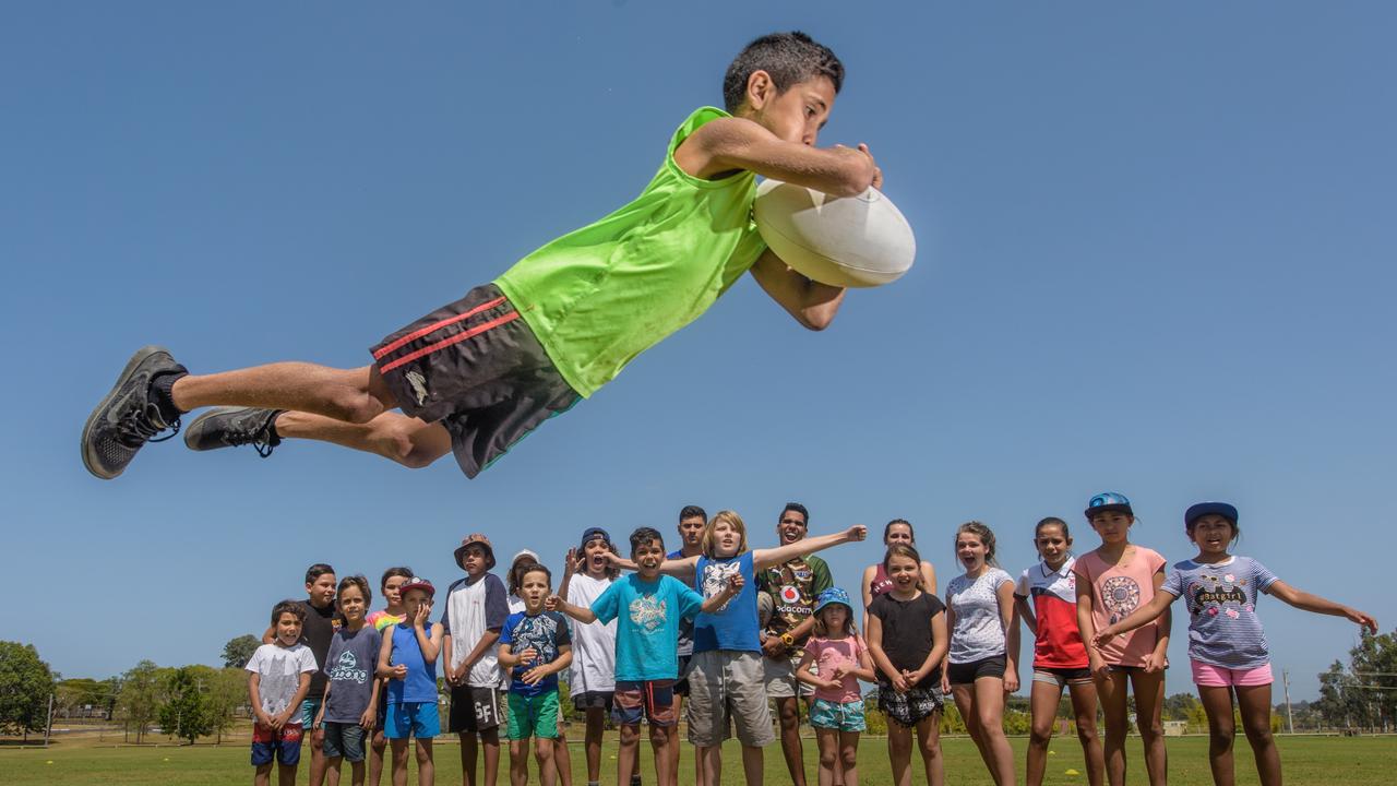 Kshawn Duroux, 11 shows some superman try-scoring style at the Camellia Cottage fun day at JJ Lawrence Field.