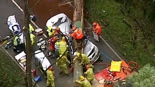 Rescue crews work frantically to free the injured from the car on the Black Spur.