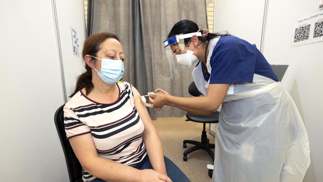 Afaf Kadar receives her second Covid vaccination at the Melbourne Showgrounds. Picture: David Geraghty