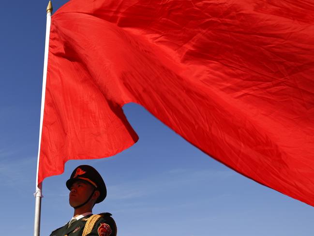 A member of a Chinese honor guard holds a red flag during a welcome ceremony for visiting Indian President Pranab Mukherjee outside the Great Hall of the People in Beijing, Thursday, May 26, 2016. (AP Photo/Andy Wong)