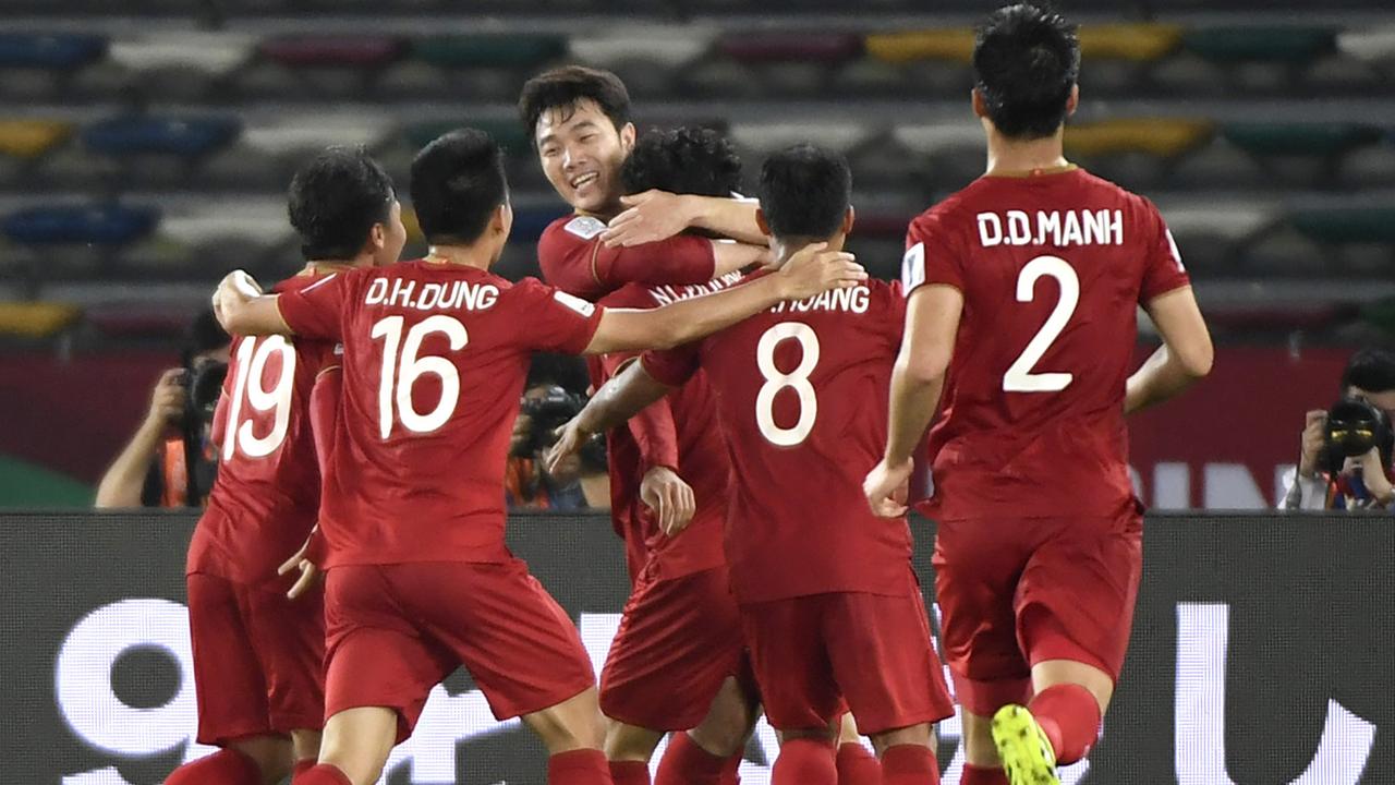 Vietnam players celebrate. (Photo by Khaled DESOUKI / AFP)