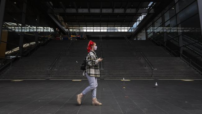 A woman walks past Southern Cross Station in Melbourne in 2020. Picture: Daniel Pockett