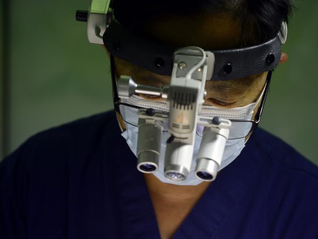 Dr Damien Foong during surgery.Photo: Claudia Baxter / The Queensland Times