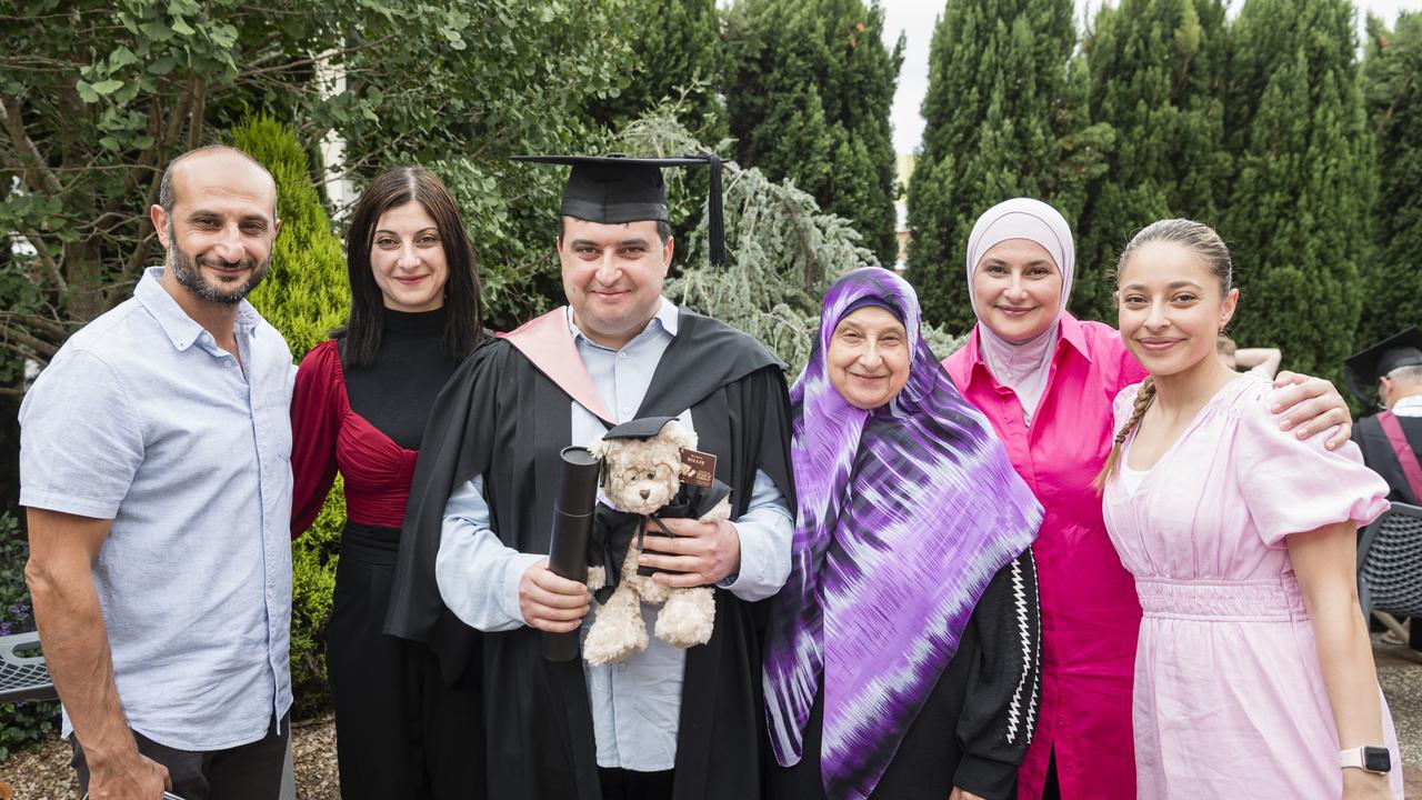 Hassan Ismail celebrates his Graduate Diploma of Early Childhood graduation with family members (from left) Hussein Ismail, Natalie Ismail, Khadiga Ismail, Samar Sakr and Kaddy Sakr at a UniSQ graduation ceremony at Empire Theatres, Tuesday, February 13, 2024. Picture: Kevin Farmer