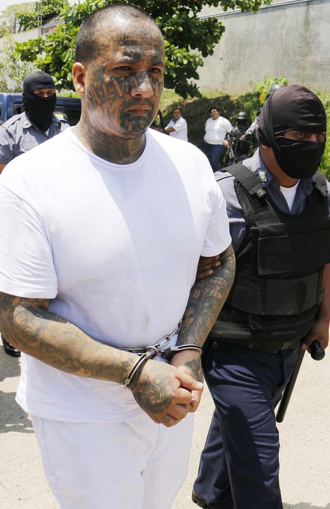 A National guardsman escorts a Mara Salvatrucha gang member in a prison transfer in Zacatecoluca, El Salvador. Picture: Marlon Gomez/Getty.