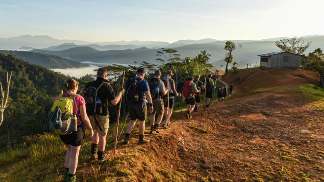 Trekkers pass through the village of Nauro on the Kokoda Track. Picture: Brad Fleet