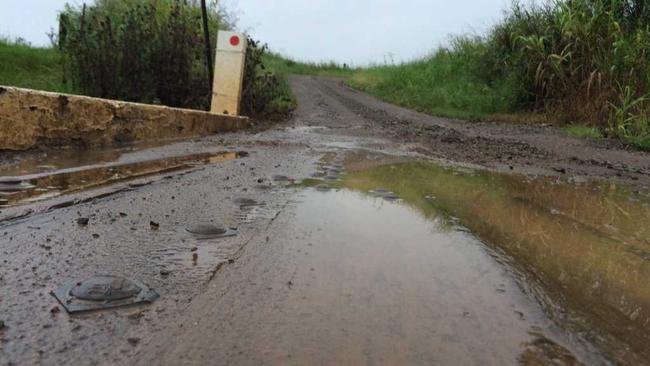 WET TO COME: Puddles line a dirt road at The Dawn ahead of Thursday's predicted downpour. Picture: Frances Klein