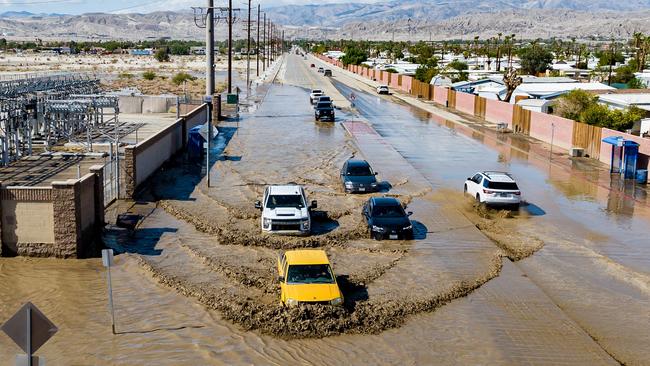 Vehicles drive through floodwaters following heavy rains from Tropical Storm Hilary in Thousand Palms, California. Picture: AFP