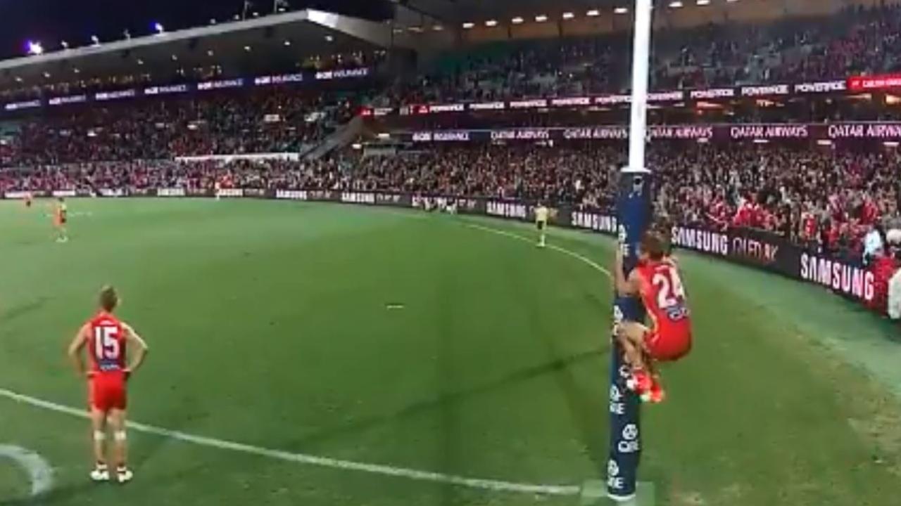 Dane Rampe jumps on the goalpost.