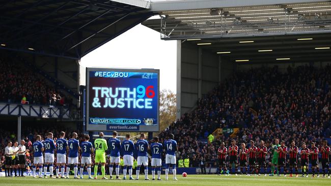 Players and supporters observe a minute of silence for the victims of the Hillsborough disaster victims.