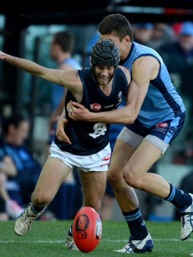 Caleb Daniel tries to slip through a tackle in the SANFL.