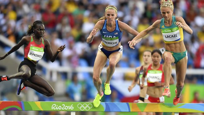 (L-R) Kenya's Hyvin Kiyeng Jepkemoi, USA's Courtney Frerichs, and Australia's Genevieve Lacaze compete in the Women's 3000m Steeplechase Round 1 during the athletics event at the Rio 2016 Olympic Games at the Olympic Stadium in Rio de Janeiro on August 13, 2016. / AFP PHOTO / Fabrice COFFRINI