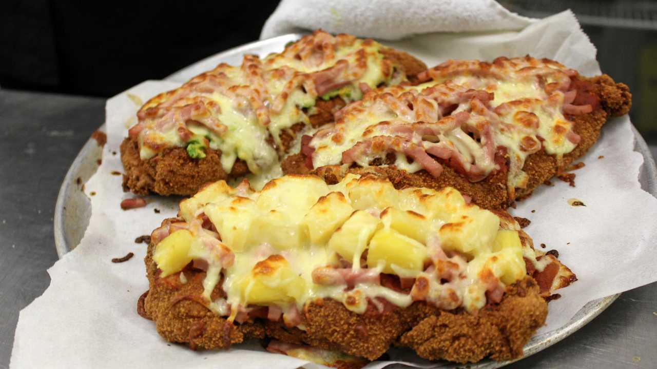 The mouthwatering Hawaiian, golden buick and traditional chicken parmies served up at the Royal Hotel in Yarraman. Picture: Laura Blackmore