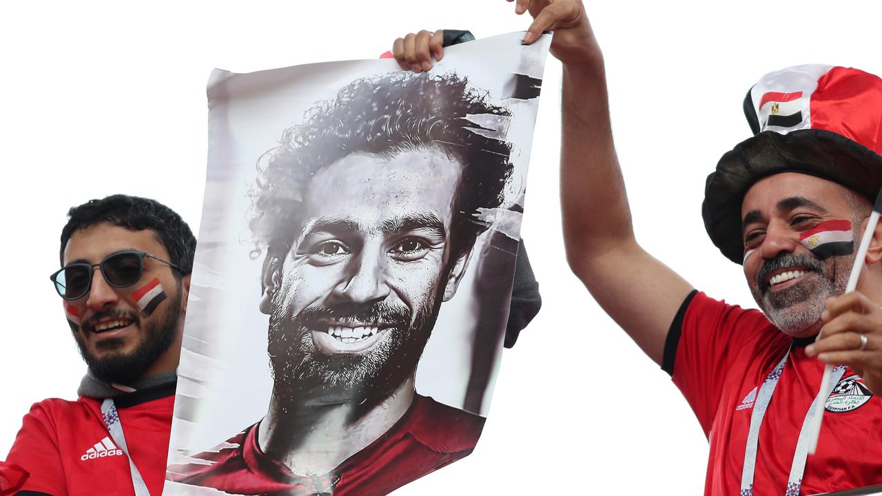 Egypt fans hold a poster of Mohamed Salah