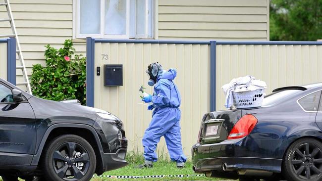 Police and forensic officers inspect a Booval property where a man was killed in 2016. Picture: David Nielsen