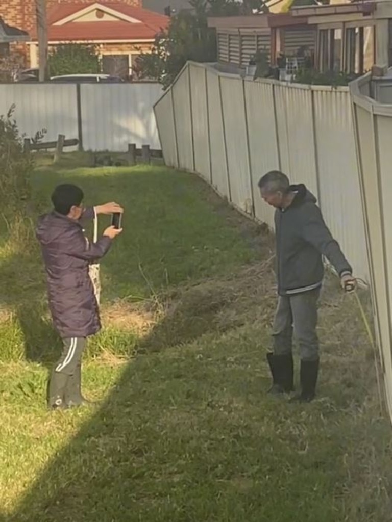 She said the couple have also been seen measuring and taking pictures of the other side of her fence. Picture: @tinnnkerrr/TikTok