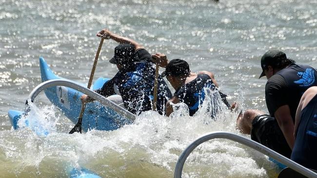 Bayside Outrigger Canoe Club paddlers punch through a wave to the start line for one of the 4 legs of the Marlin Coast Challenge. Photo: Steve Lewis