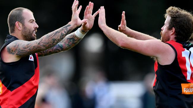 Dean Galea of Riddell is congratulated by Haydn Ross after kicking a goal during the round two RDFNL Bendigo Bank Seniors match between Riddell and Kyneton at Riddells Creek Recreation Reserve, on April 13,2024, in Diggers Rest, Australia. (Photo by Josh Chadwick)