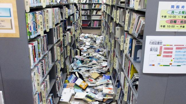 Books are scattered on the floor at a library in Iwaki, Fukushima prefecture after a strong earthquake on November 22, 2016. Picture: Kyodo News via AP