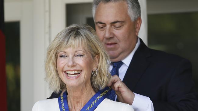 Olivia Newton-John receives her award from Joe Hockey. Picture: Danny Moloshok