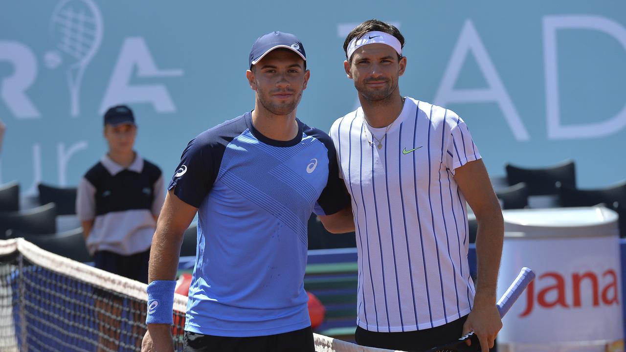 Dimitrov, right, poses for cameras with Croatia's Borna Coric during their semi-final. Picture: AP