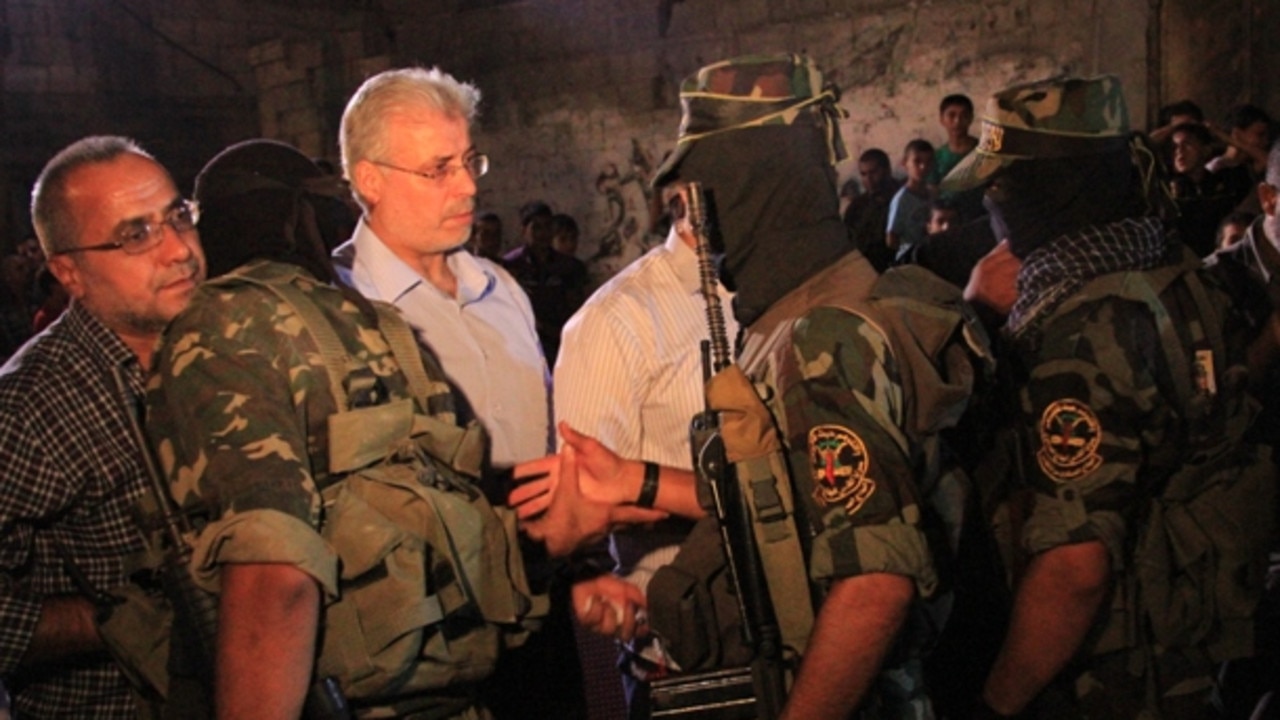 At a 2012 memorial for his son, Fayez Elhasani can be seen greeting members of Palestinian Islamic Jihad.