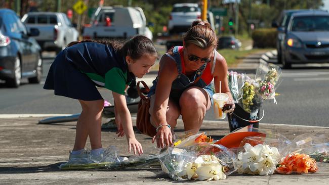 Nicole and Taliah Connor leaving flowers at the site of the accident. Picture: Justin Lloyd.