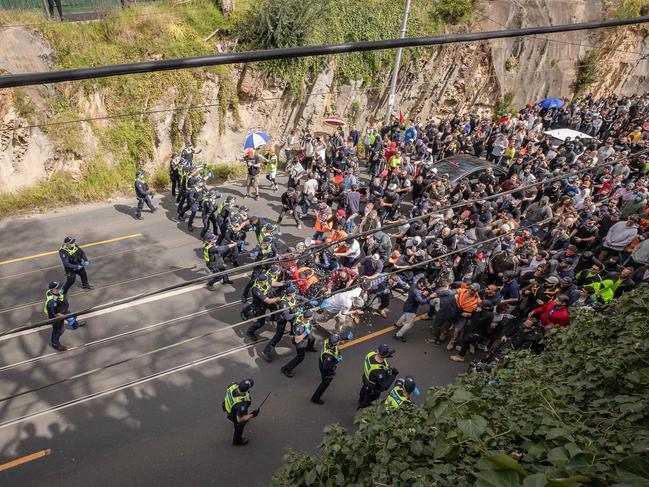 Protesters were seen linking arms before charging at police. Picture: Jason Edwards