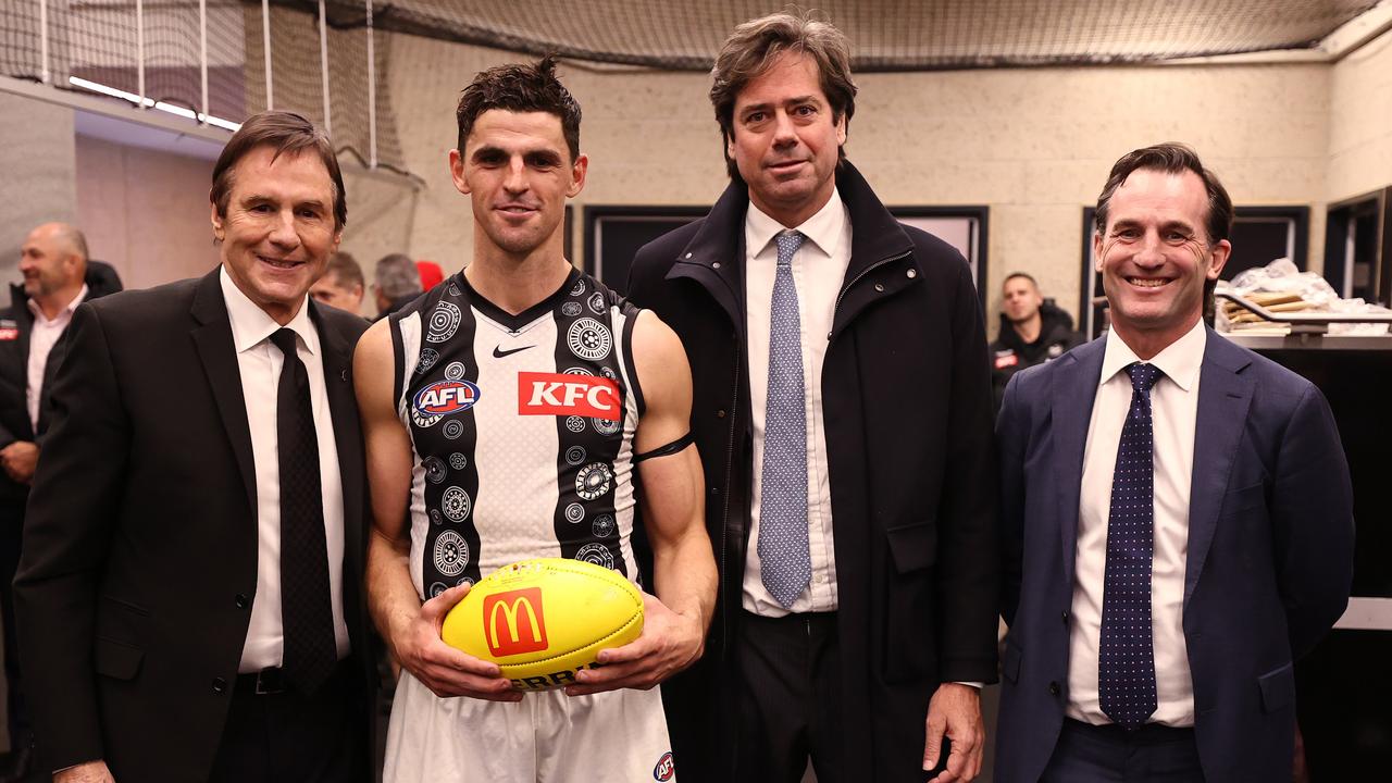 MELBOURNE - July 7 : AFL. Scott Pendlebury of the Magpies receives the match ball from AFL CEO Gillon McLachlan, Andrew Dillon and Collingwood president Jeff Browne after breaking the games possession record during the round 17 AFL match between Western Bulldogs and Collingwood at Marvel Stadium on July 7, 2023. Photo by Michael Klein.