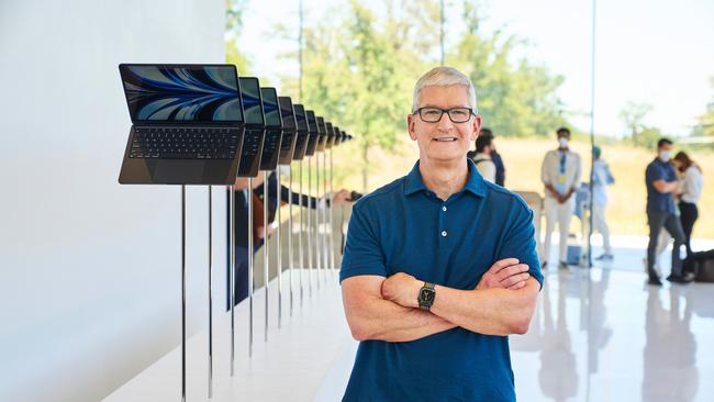 Apple CEO Tim Cook poses with the 2022 MacBook Air.