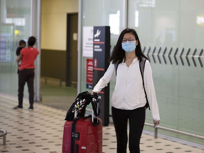 Passengers arrive at Brisbane International Airport on Sunday. Picture: AAP