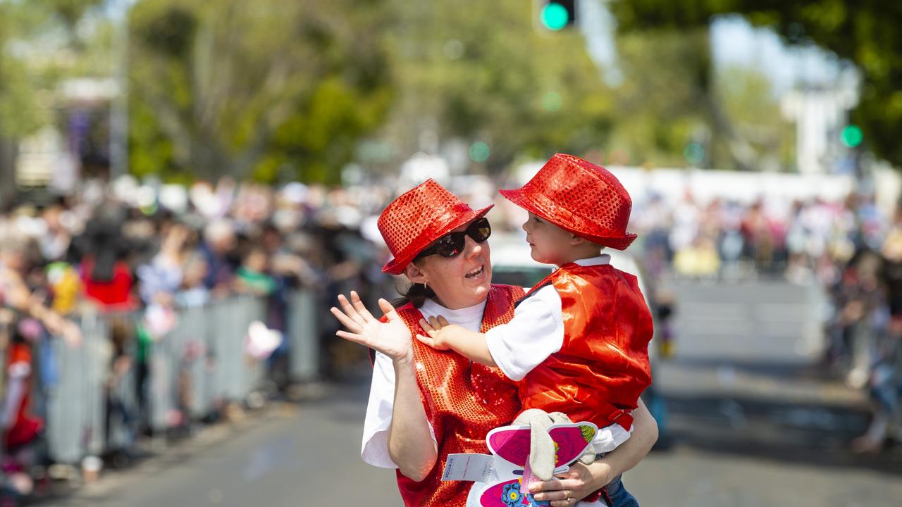 Krystal and Thatcher Ward-Pearson walking with the Heritage Bank float Grand Central Floral Parade of Carnival of Flowers 2022, Saturday, September 17, 2022. Picture: Kevin Farmer