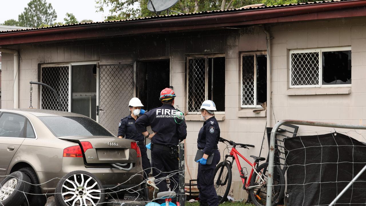 Investigators at the crime scene of a suspicious fire at Landsborough where a house and car were destroyed on Sunday night. Picture Lachie Millard