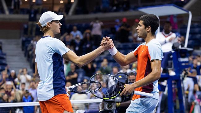 Spain’s Carlos Alcaraz (R) greets Italy’s Jannik Sinner at the net after their US Open quarter-final last year. Picture: AFP.