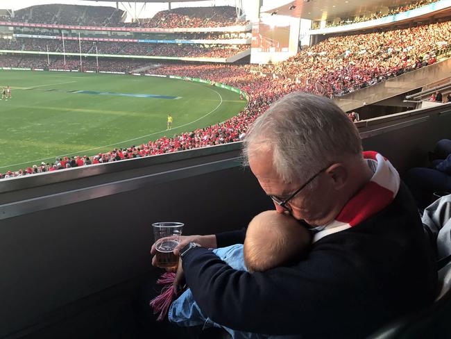 Prime Minister Malcolm Turnbull drew criticism holding his granddaughter Alice while drinking a beer.