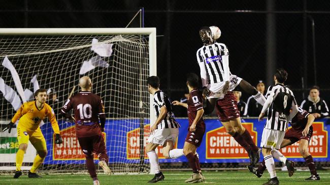 Moreland Zebras midfielder Gai Gai rises to win a header.