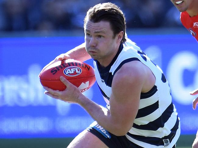 Patrick Dangerfield of the Cats (left) and Jarryd Lyons of the Suns are seen in action during the Round 23 AFL match between the Geelong Cats and the Gold Coast Suns at GMHBA Stadium in Geelong, Saturday, August 25, 2018. (AAP Image/Julian Smith) NO ARCHIVING, EDITORIAL USE ONLY