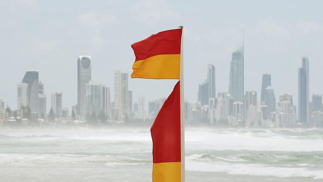 The famous red and yellow swimming flags with a Gold Coast skyline backdrop. Picture: Brendan Radke.