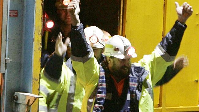  Tasmanian miners Todd Russell and Brant Webb (obscured) wave as they emerge from the mine lift having been rescued after bei...