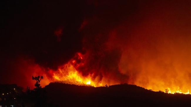 Huge flames approaching Peregian Beach. Picture: Lachie Millard